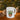 Glossy white ceramic mug with cute potted succulent and "I Wet My Plants" lettering on windowsill