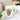 Glossy white ceramic mug with cute potted succulent and "I Wet My Plants" lettering on windowsill