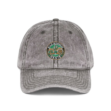 Vintage cap with Wild Wonders Oasis embroidered logo, washed-out cotton twill, distressed finish, and antique brass buckle